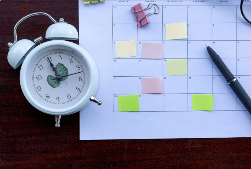 assistant organizing client schedule on a calendar