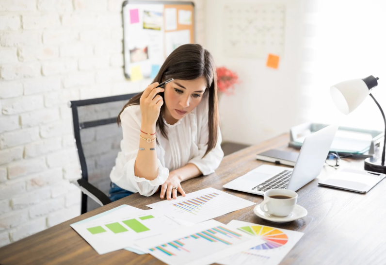 Business owner reviewing financial reports with a virtual assistant via video call.
